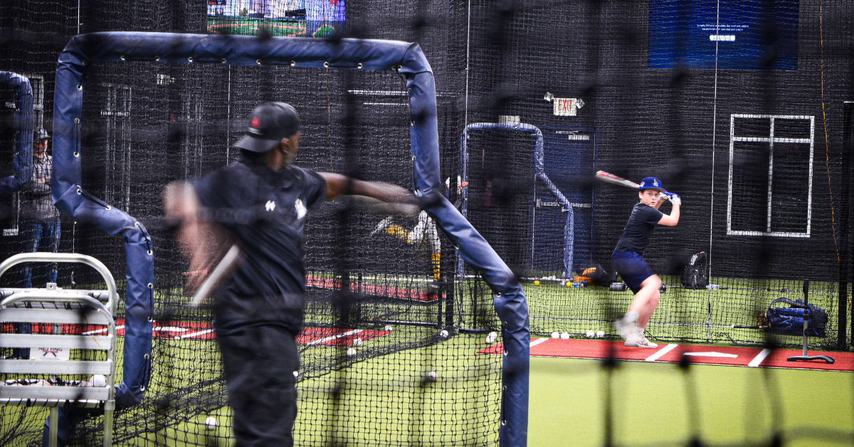 baseball batter and pitcher practicing in arena lake norman rental cage