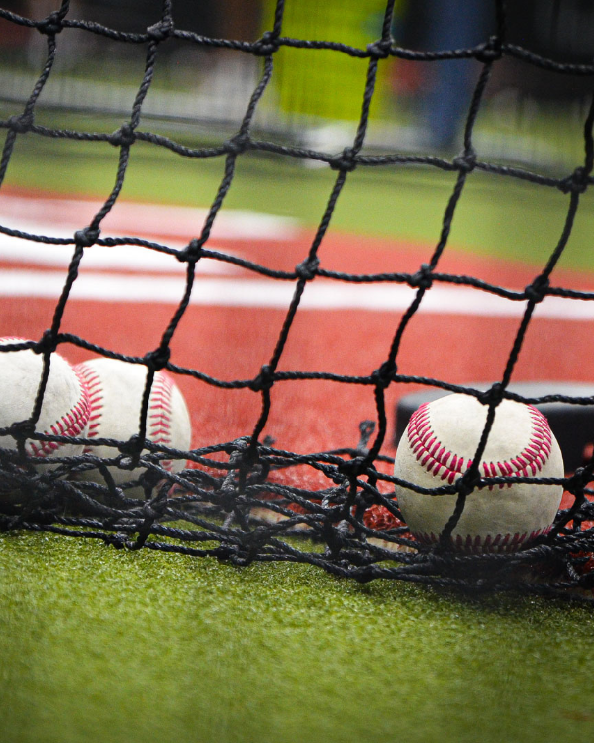 baseballs on ground in rental batting cages at arena lake norman
