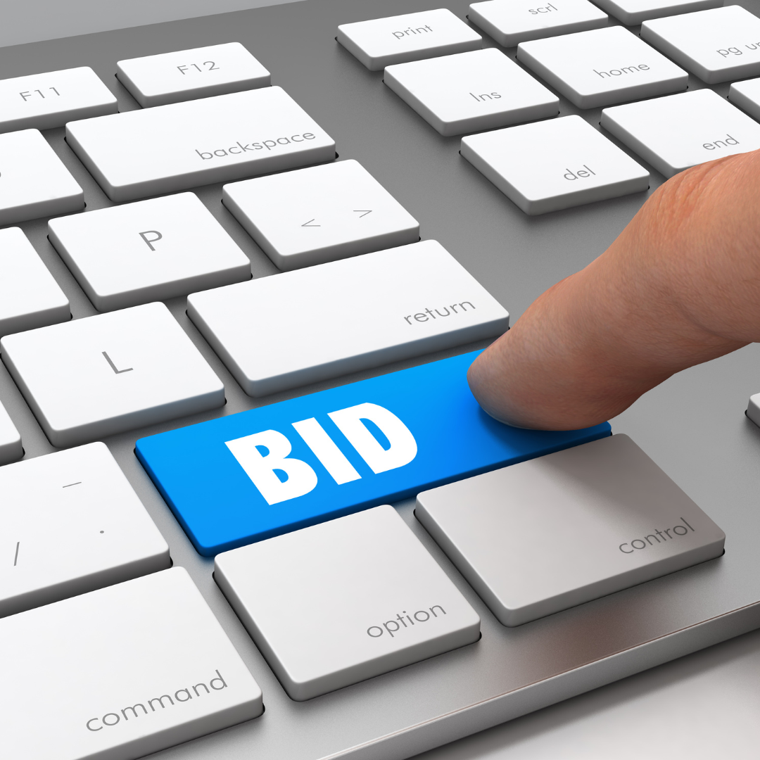 marketer clicking blue bid button on keyboard